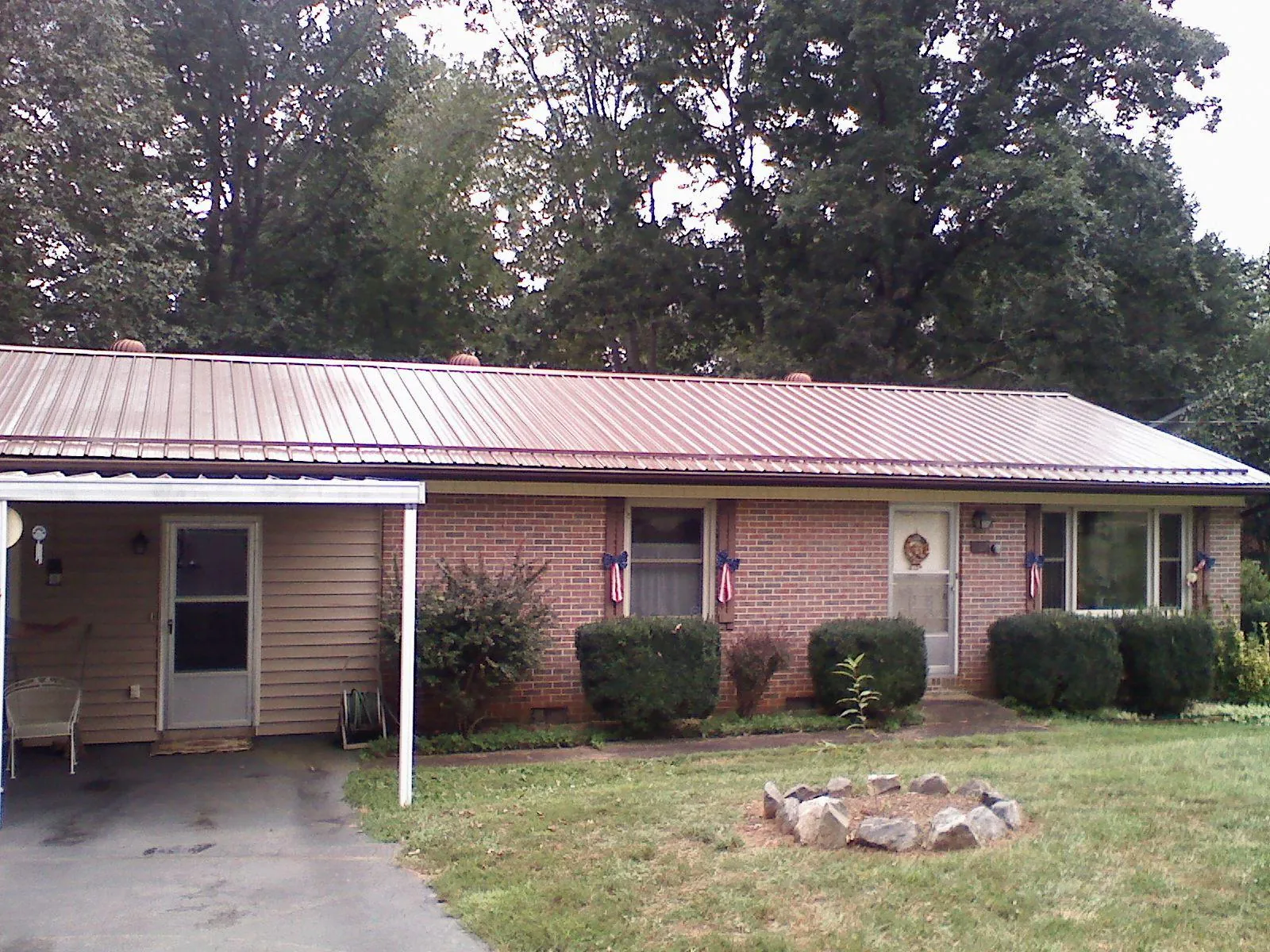 Bronze metal roof and carport on a brick ranch home — Roof Repair work by our crew in Newhall