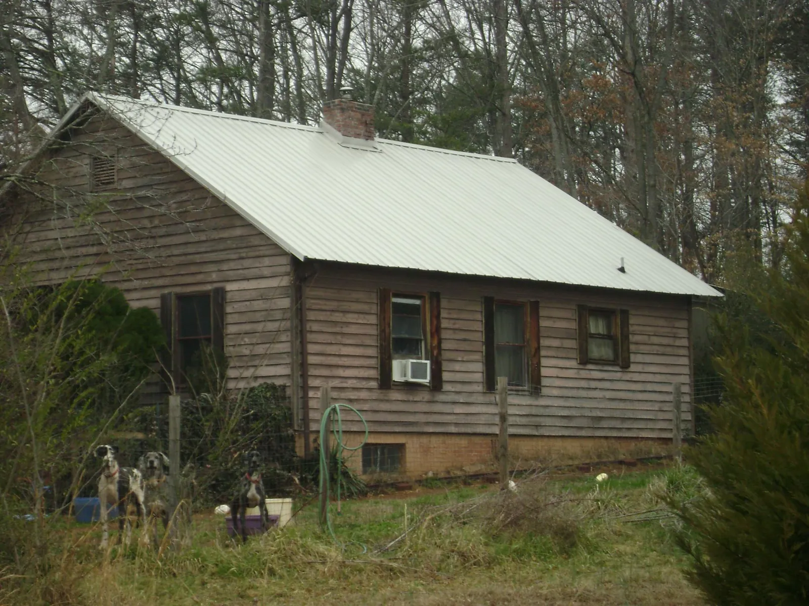 White metal roof on an old wood sided farmhouse, from a Metal Roof Installation job in Newhall